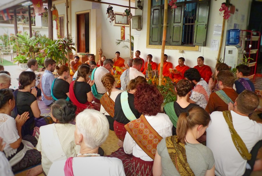 Volunteers participating in a religious Basci cermony, whereby Novices and Monks bless the building to rid it of bad spirits for the new year.